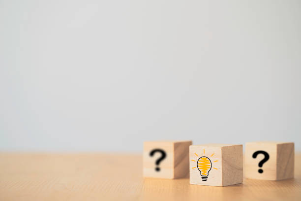 Illustration lightbulb icon and question mark print screen on wooden block cube. It is creative thinking idea and innovation concept. Illustration lightbulb icon and question mark print screen on wooden block cube. It is creative thinking idea and innovation concept. frequently asked questions stock pictures, royalty-free photos & images