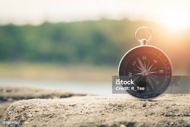 Compass Of Tourists On Mountain At Sunset Sky Stock Photo - Download Image Now - Navigational Compass, Drawing Compass, Sky