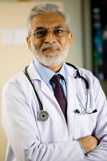 istock Senior male doctor looking at camera 1298791813