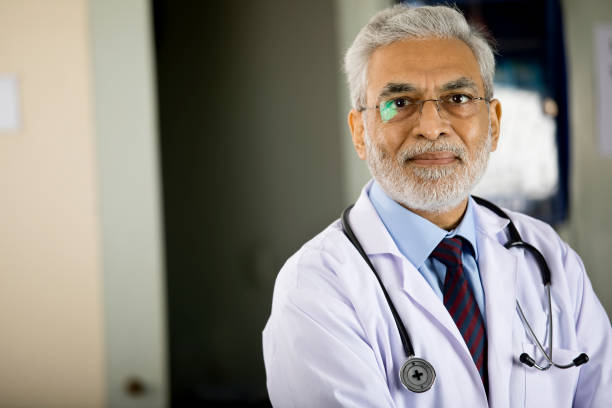 istock Senior male doctor looking at camera 1298791841