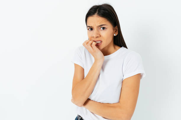 istock Scared brunette woman in a t-shirt 1298794587