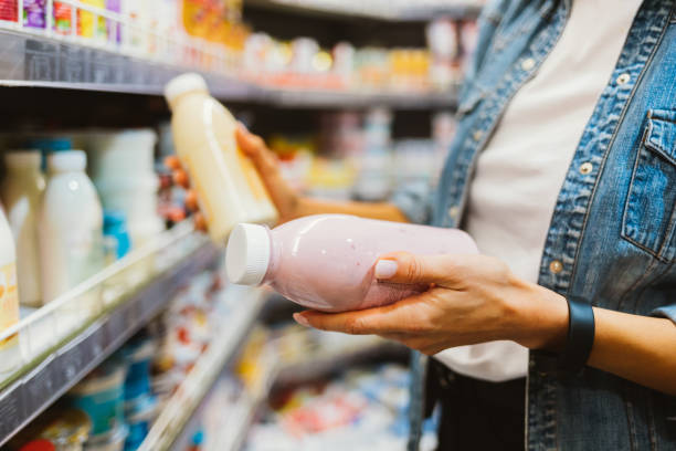 Close-up of bottled dairy products in female hands