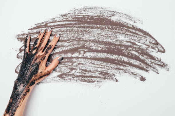 istock Top view woman's hand with applied cosmetic scrub mask 1298794693