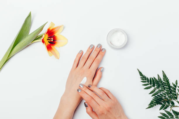 istock Top view woman applying hand cream among green leaf 1298794708