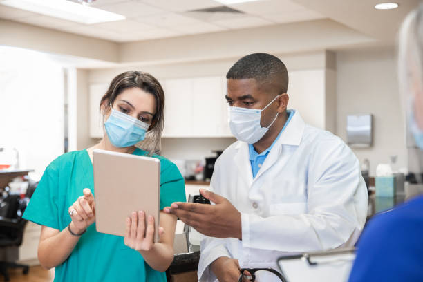 istock Nurse and doctor going over a patients test results 1298796615