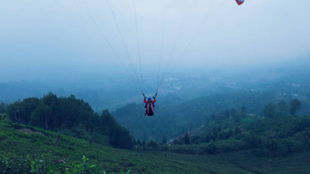 istock Paragliding over a tea plantation in the Puncak Bogor area, West Java, one afternoon 1298806354