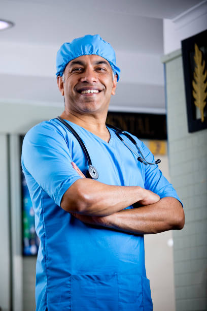 istock Happy male surgeon with arms crossed 1298808162