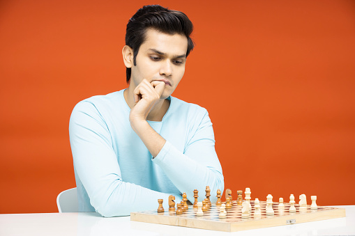 Man playing chess during tournament at table indoors