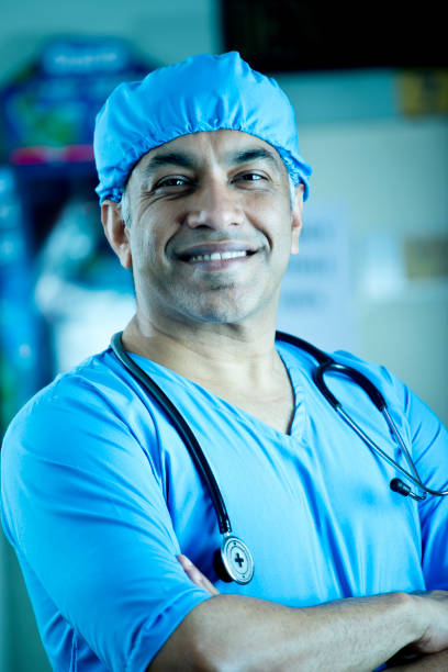istock Happy male surgeon with arms crossed 1298808517