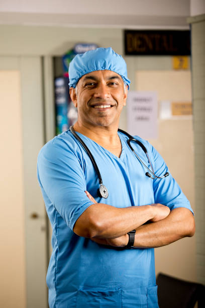 istock Happy male surgeon with arms crossed 1298809258
