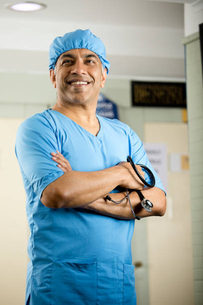 istock Happy male surgeon with arms crossed 1298809388