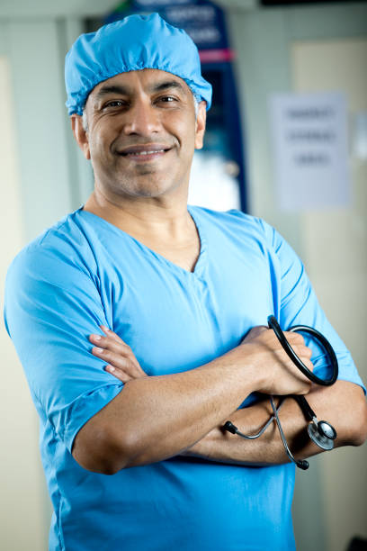 istock Happy male surgeon with arms crossed 1298809917