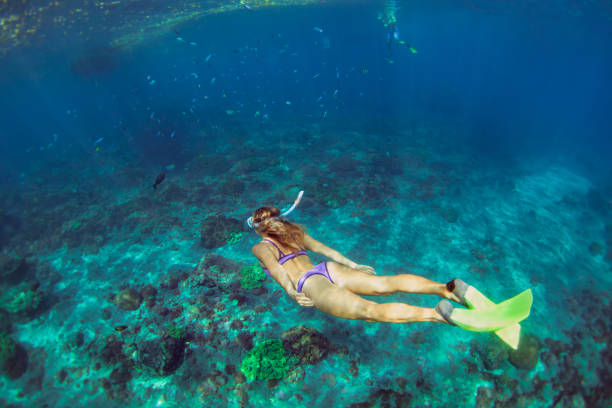 istock Young woman diving underwater 1298809948