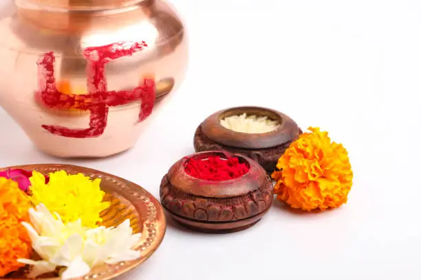 Beautifully Decorated Pooja Thali for festival celebration to worship, rice grain and Kumkum, flowers, Hindu puja thali.