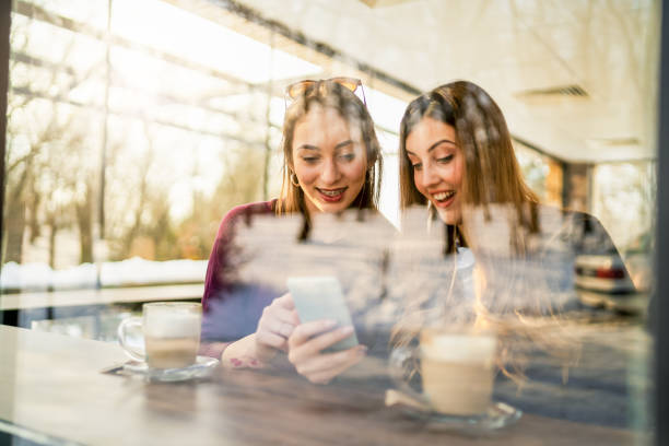 istock Two Women Sitting In Coffee Shop 1298813418