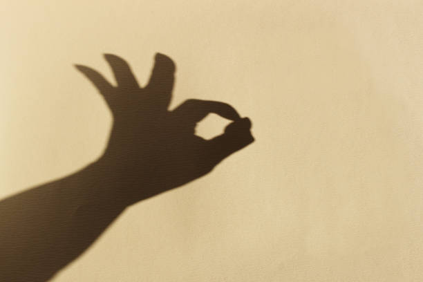 istock OK Hand sigh shadow on beige paper 1298814699