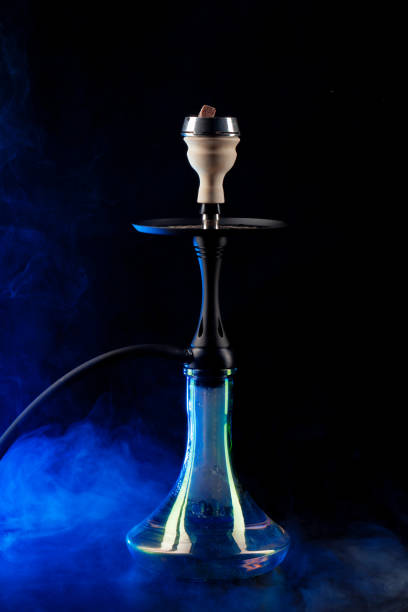 istock Smoking hookah on black background with color fog 1298814965