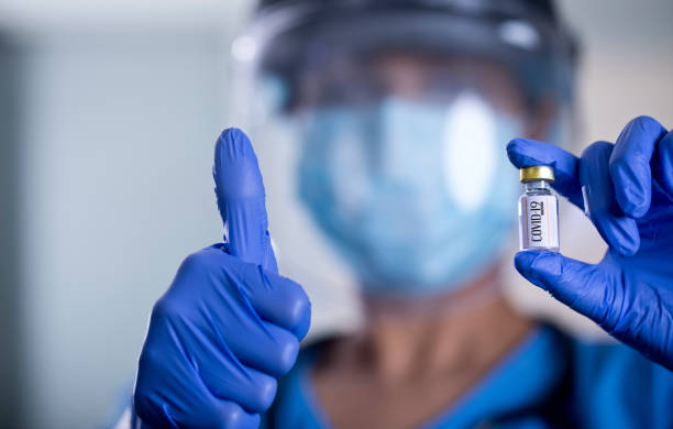 istock Doctor holding covid-19 vaccine 1298816310