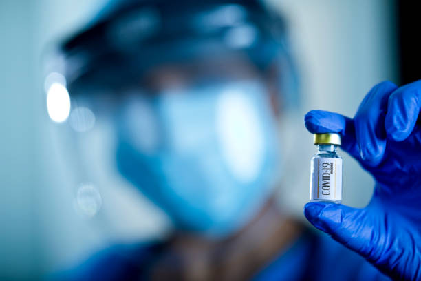 istock Doctor holding covid-19 vaccine 1298816361