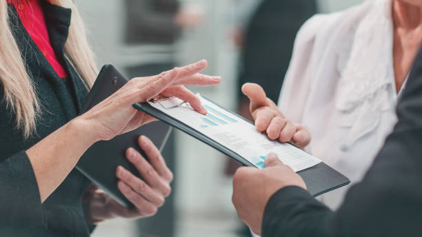 istock group of competent employees discussing business documents 1298817866