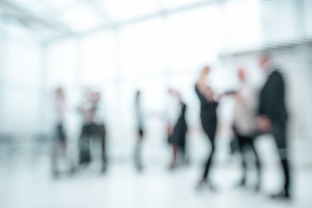 background image of company employees standing in the office lobby stock photo