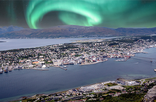 Bodo harbor on a cloudy day in the north of Norway with aurora borealis in the sky.