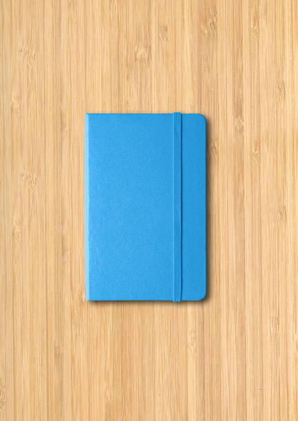 istock Blue closed notebook on wooden background 1298825867
