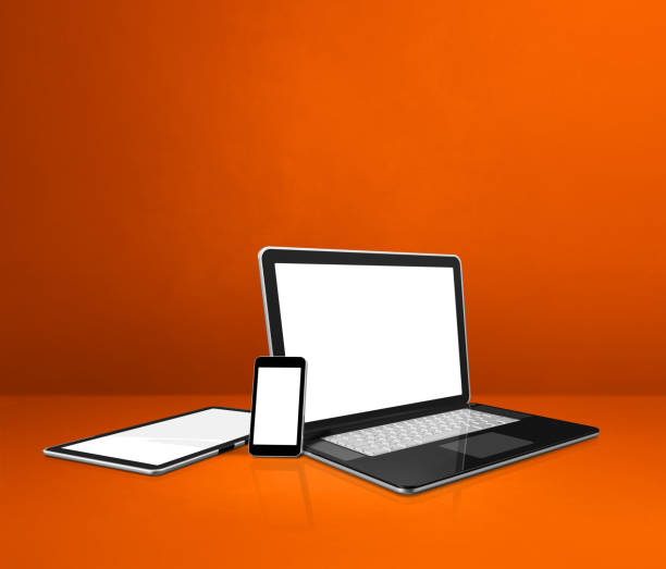 istock Laptop, mobile phone and digital tablet pc on orange office desk 1298826109