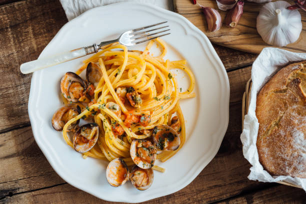 Fresh bigoli with seafood with tomato sauce.