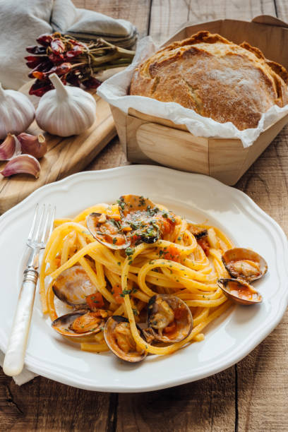 istock Fresh bigoli with seafood with tomato sauce. 1298828512