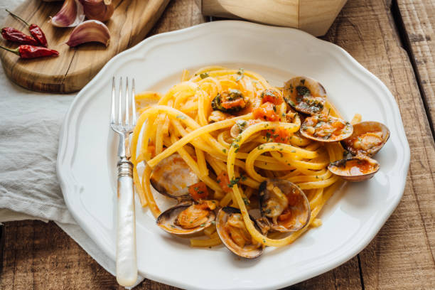 istock Fresh bigoli with seafood with tomato sauce. 1298828555
