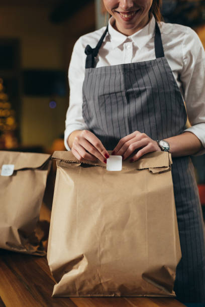 istock waitress preparing take away food in restaurant 1298829790