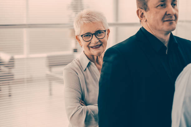 istock group of employees people standing in a row 1298831024