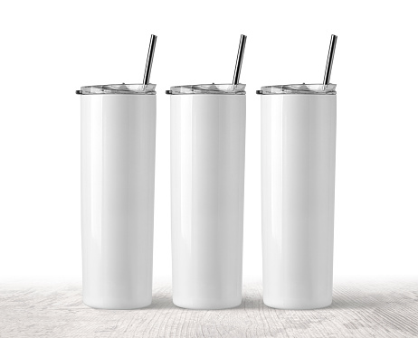 Three Blank Stainless Steel Tumbler with Lid for branding mock up. on wooden  table