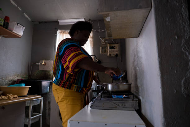 istock African woman cooking on a gas burner 1298834270