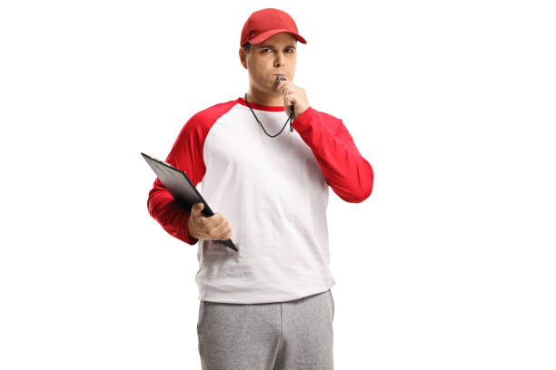 Angry baseball coach holding a clipboard and blowing a whistle Angry baseball coach holding a clipboard and blowing a whistle isolated on white background whistling stock pictures, royalty-free photos & images