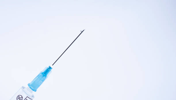 istock open disposable syringe with drop of liquid 1298840844