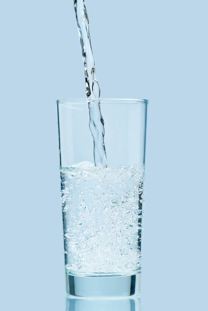 istock Pouring water. Pouring fresh clean drinking water to glass. 1298841449
