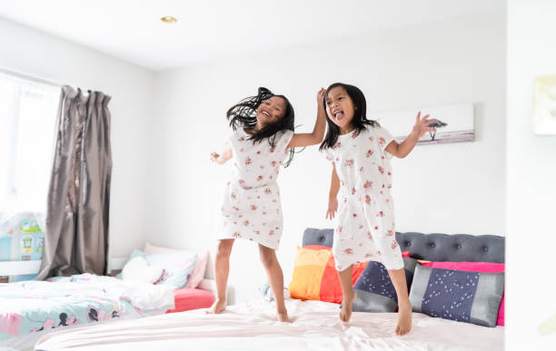istock Kids enjoying in bed room. 1298843107