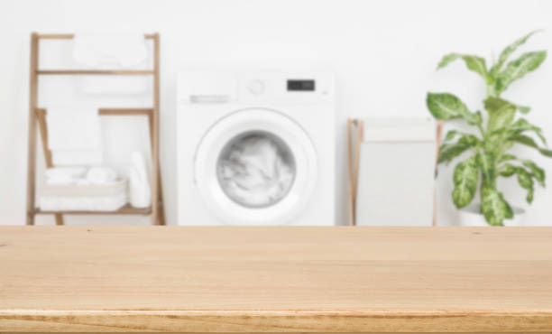 istock Empty wooden board over blurred laundry room washing machine background 1298844098
