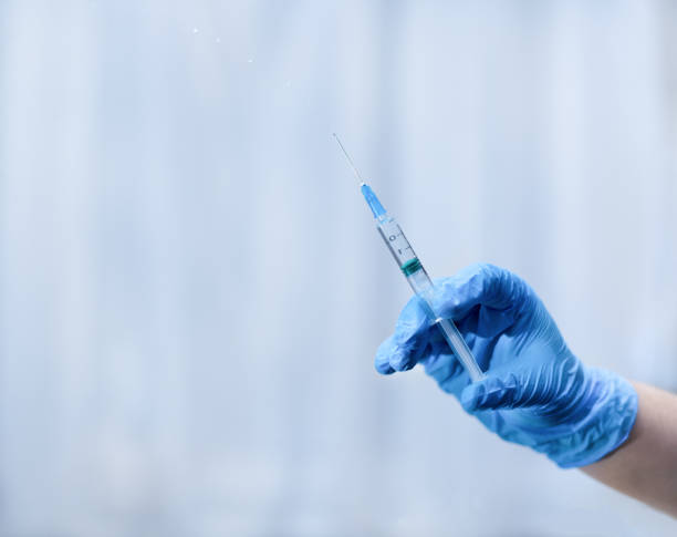 istock A hand in a medical glove holds a syringe 1298845691