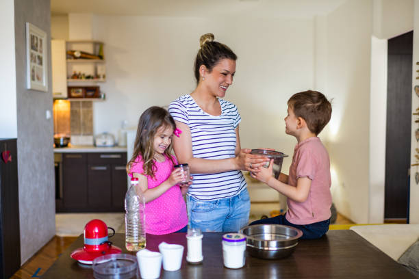 istock Happy family making cake together 1298847791