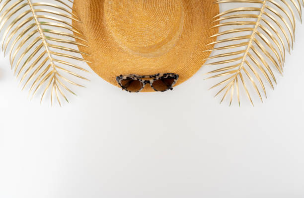istock Straw hat and sunglasses top view on white background 1298850149