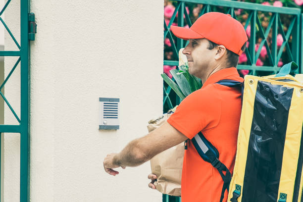 istock Food courier in uniform with isothermal backpack 1298850163