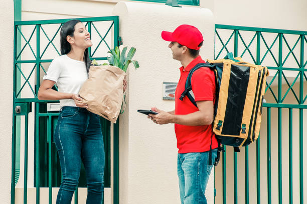 istock Courier delivering paper package with food to customers 1298852152