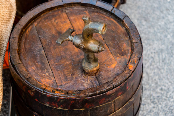 High angle view of antique wooden beer barrel with bronze faucet