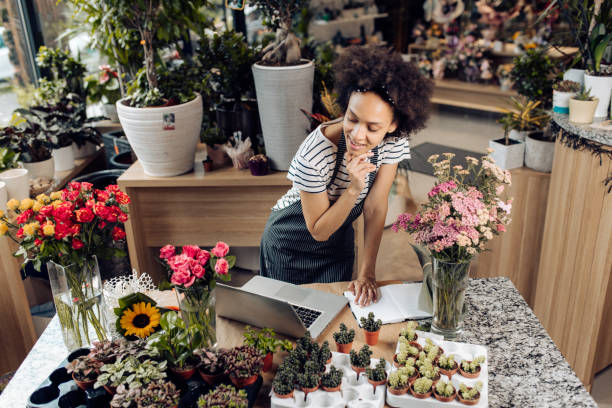 istock Young florist making a business plan at her store 1298855963
