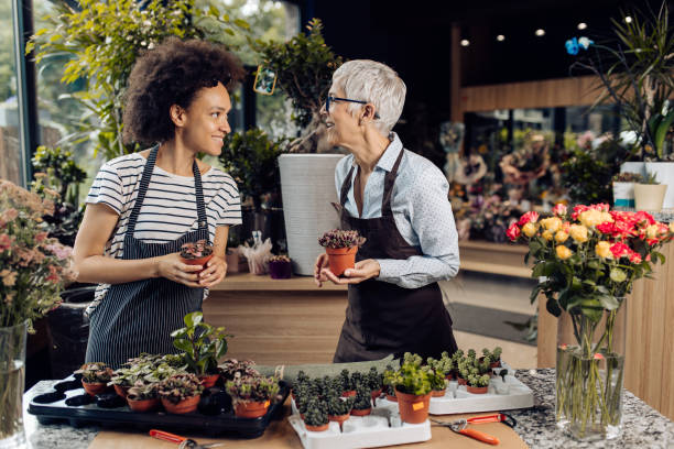 istock Two florists preparing their reopened store for sale 1298856002