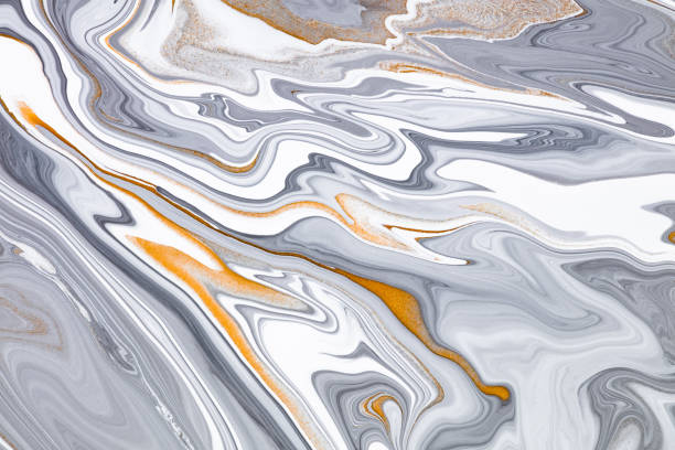 istock Fluid art texture. Abstract background with mixing paint effect. Liquid acrylic artwork with chaotic mixed paints. Can be used for posters or wallpapers. Black, white and golden overflowing colors. 1298856423