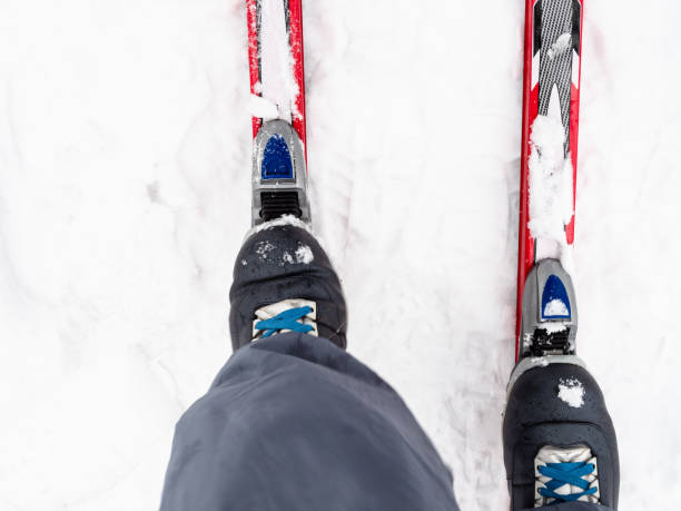 istock skier fixes boot to plastic skis at snow in winter 1298857011